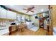 Functional laundry room with built-in cabinets, countertops, and a ceiling fan at 8842 Rocky Ridge Rd, Indianapolis, IN 46217