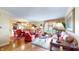 Spacious living room featuring hardwood floors, elegant furnishings, and a view into the dining area at 8842 Rocky Ridge Rd, Indianapolis, IN 46217