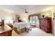 Spacious main bedroom with plush carpet, a ceiling fan, and decorative window treatments for a cozy retreat at 8842 Rocky Ridge Rd, Indianapolis, IN 46217