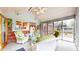 Cozy screened porch with brick accent wall and comfortable white wicker furniture for relaxed outdoor living at 8842 Rocky Ridge Rd, Indianapolis, IN 46217