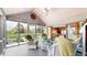Charming sunroom with vaulted ceilings, comfortable wicker furniture and peaceful views of the backyard pond at 8842 Rocky Ridge Rd, Indianapolis, IN 46217