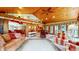 This sunroom has a wooden ceiling, large windows, and comfortable seating at 8842 Rocky Ridge Rd, Indianapolis, IN 46217