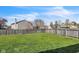 Spacious backyard features a green lawn, wooden fence, and mature trees at 8888 N White Tail N Trl, McCordsville, IN 46055
