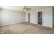 Large carpeted bedroom featuring a ceiling fan, closet, and two doors at 8888 N White Tail N Trl, McCordsville, IN 46055