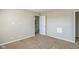 A carpeted bedroom featuring a door and a neutral color palette at 8888 N White Tail N Trl, McCordsville, IN 46055