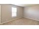 A carpeted bedroom features a window for natural light and neutral decor at 8888 N White Tail N Trl, McCordsville, IN 46055