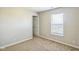 A carpeted bedroom features a window, door, and neutral color palette at 8888 N White Tail N Trl, McCordsville, IN 46055