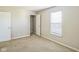 A carpeted bedroom with a closet, doors, and a window for natural light at 8888 N White Tail N Trl, McCordsville, IN 46055