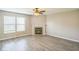 Bright living room with a fireplace, fan, and modern gray vinyl flooring at 8888 N White Tail N Trl, McCordsville, IN 46055