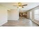 Spacious living room leading to kitchen, featuring gray floors, and bright natural light at 8888 N White Tail N Trl, McCordsville, IN 46055
