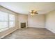 The living room features neutral walls, a ceiling fan, and a fireplace at 8888 N White Tail N Trl, McCordsville, IN 46055