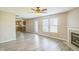 Open floor plan with a fireplace in the living room and view into the kitchen at 8888 N White Tail N Trl, McCordsville, IN 46055