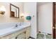 Bathroom with single sink vanity, framed mirror, decorative sconces, a hand towel and step-in shower at 990 Broadway N Dr, Plainfield, IN 46168