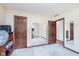 Spacious bedroom featuring three doors, each with mirrors, plus neutral color paint, and carpeted floor at 990 Broadway N Dr, Plainfield, IN 46168