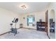 Bedroom featuring an exercise bike and sound system, plus window with curtains, and carpeted floor at 990 Broadway N Dr, Plainfield, IN 46168