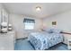 Bedroom features a patterned bedspread, a side table, dresser and large window with decorative blinds at 990 Broadway N Dr, Plainfield, IN 46168