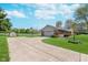 Long concrete driveway leading to a two-car garage with basketball hoop at 990 Broadway N Dr, Plainfield, IN 46168