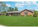 Beautiful brick ranch-style home with a lush green lawn and mature landscaping at 990 Broadway N Dr, Plainfield, IN 46168