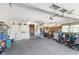 Spacious garage featuring a washer, dryer, storage cabinets, work bench, carpeted floors, and tools at 990 Broadway N Dr, Plainfield, IN 46168