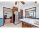 Kitchen featuring breakfast bar, stainless steel refrigerator and view of the dining and living areas at 990 Broadway N Dr, Plainfield, IN 46168