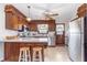 Traditional kitchen with wood cabinets, stainless steel appliances, peninsula with barstool seating, and bright, neutral countertops at 990 Broadway N Dr, Plainfield, IN 46168