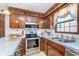 Kitchen featuring wooden cabinets, stainless steel appliances, a double basin sink and bright countertops at 990 Broadway N Dr, Plainfield, IN 46168