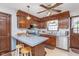 Traditional kitchen with wood cabinets, stainless steel appliances, peninsula with barstool seating, and bright, neutral countertops at 990 Broadway N Dr, Plainfield, IN 46168