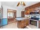 Kitchen with stainless appliances and view into dining room; includes breakfast bar with stools at 990 Broadway N Dr, Plainfield, IN 46168