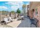 Outdoor patio with white table and chairs, surrounded by a brick home and wood fence at 990 Broadway N Dr, Plainfield, IN 46168