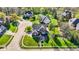 Aerial view of a brick house on a well-manicured lawn in a lush neighborhood at 10715 Hamilton Pass, Fishers, IN 46037