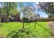 Spacious backyard with a well-maintained lawn, mature trees, and a deck with furniture at 10715 Hamilton Pass, Fishers, IN 46037