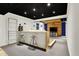 Basement bar area featuring seating, shelving, and a nearby living space at 10715 Hamilton Pass, Fishers, IN 46037