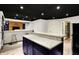 Basement bar with granite countertops, bar seating, and an adjacent entertainment area at 10715 Hamilton Pass, Fishers, IN 46037