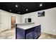 Basement bar with dark cabinets, granite counters, an island, and a bathroom at 10715 Hamilton Pass, Fishers, IN 46037