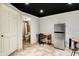 Finished basement area featuring a mini fridge, desk, and adjacent bathroom at 10715 Hamilton Pass, Fishers, IN 46037