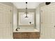 Bright bathroom showing large soaker tub with travertine tile surround and neutral accents at 10715 Hamilton Pass, Fishers, IN 46037