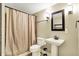 Cozy bathroom with pedestal sink, tile accents, and neutral wall color at 10715 Hamilton Pass, Fishers, IN 46037