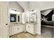 Bright bathroom boasting dual vanities with granite countertops and travertine tile flooring at 10715 Hamilton Pass, Fishers, IN 46037