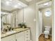 Bathroom featuring granite counters, a large mirror, and a toilet with window at 10715 Hamilton Pass, Fishers, IN 46037