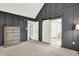 Stylish bedroom featuring elegant gray walls, barn door, and sophisticated decor elements at 10715 Hamilton Pass, Fishers, IN 46037