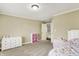 Bedroom with carpeted floor, neutral walls, and a glimpse into the upper level of the home at 10715 Hamilton Pass, Fishers, IN 46037