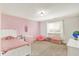 Bright bedroom showcasing natural light, neutral carpet, and pink accents at 10715 Hamilton Pass, Fishers, IN 46037