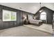 Bedroom with gray paneled walls, carpeting, and a tray ceiling with a fan at 10715 Hamilton Pass, Fishers, IN 46037