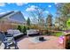Charming deck area featuring stylish outdoor seating, a basketball hoop, and a beautiful backyard view at 10715 Hamilton Pass, Fishers, IN 46037