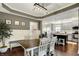 This dining area is open to the kitchen and features hardwood floors and wainscoting at 10715 Hamilton Pass, Fishers, IN 46037