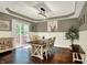 This dining room features hardwood floors, wainscoting, modern lighting and sliding door access to the deck at 10715 Hamilton Pass, Fishers, IN 46037