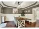 This dining area is accented by modern lighting, wainscoting, and has hardwood floors at 10715 Hamilton Pass, Fishers, IN 46037