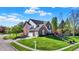 Two-story brick home with attached garage and well-manicured lawn at 10715 Hamilton Pass, Fishers, IN 46037