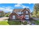 Beautiful brick home with manicured lawn and landscaped stone steps to front entrance at 10715 Hamilton Pass, Fishers, IN 46037