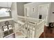 Bright foyer with white staircase, dark hardwood floors, and a view of the front entry at 10715 Hamilton Pass, Fishers, IN 46037